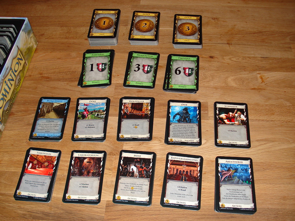 Sixteen stacks of cards of Dominion card game